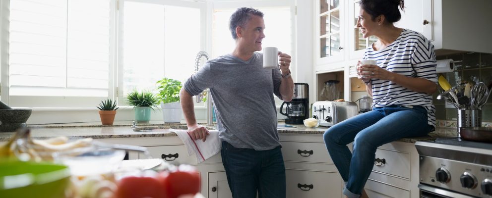 Husband and wife discussing their budget over coffee