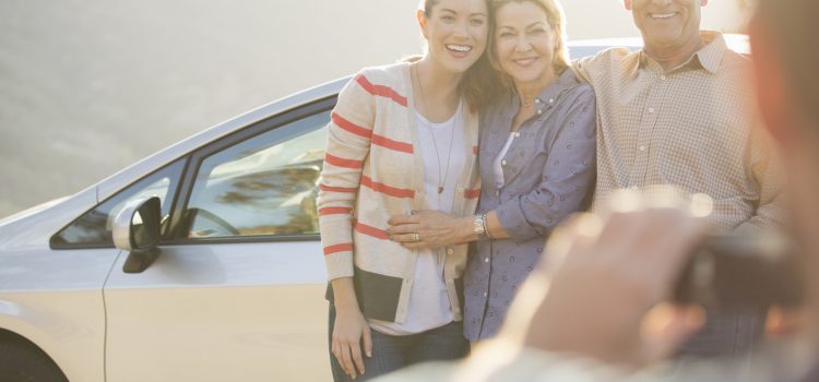 Parents and college-aged daughter smiling for a photograph