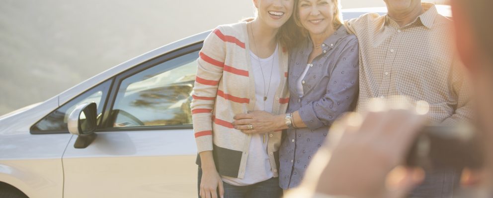 Parents and college-aged daughter smiling for a photograph