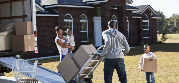 A wife and husband and their two young sons moving out of their house.
