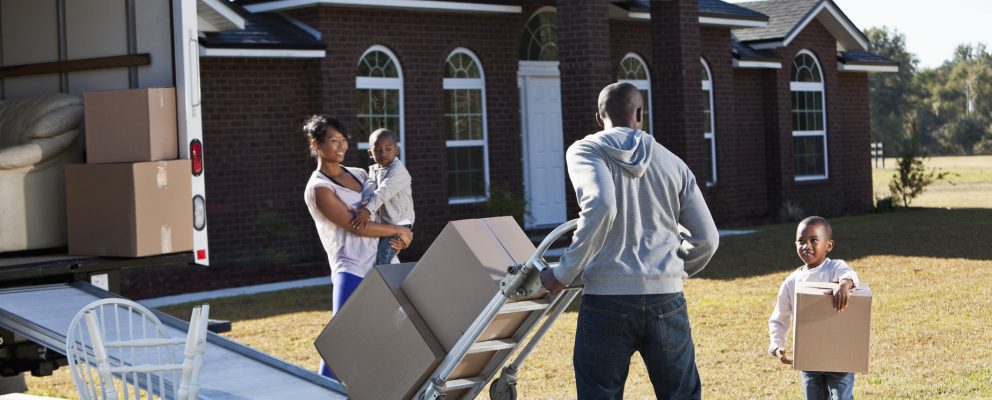 A wife and husband and their two young sons moving out of their house.