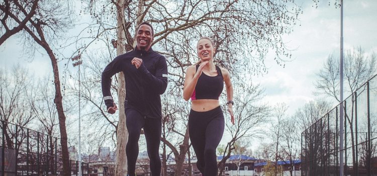 A man and a woman jog outside.