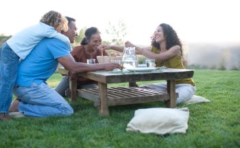 Grandparents share a meal with their daughter and grandchild.