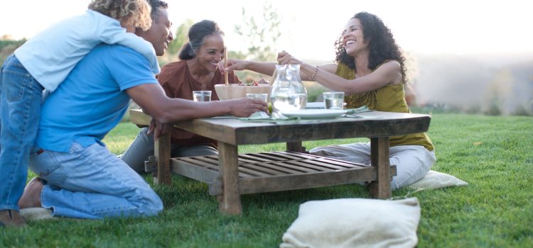 Grandparents share a meal with their daughter and grandchild.