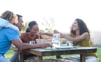 Grandparents share a meal with their daughter and grandchild.