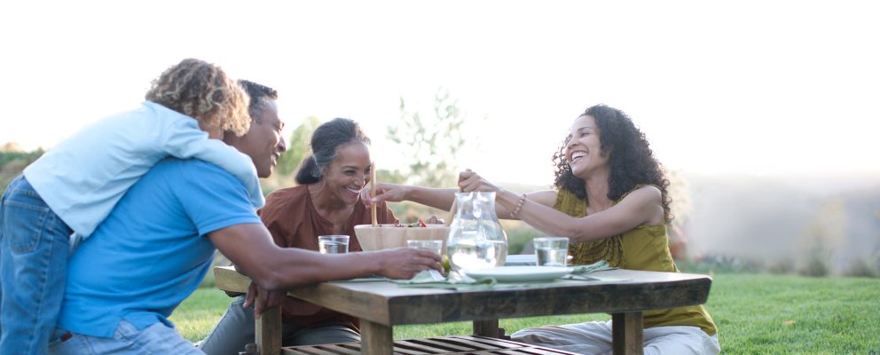 Grandparents share a meal with their daughter and grandchild.