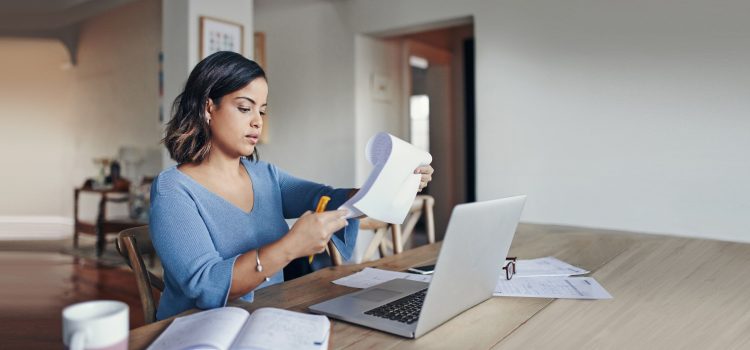 A woman reads off a list in her apartment.