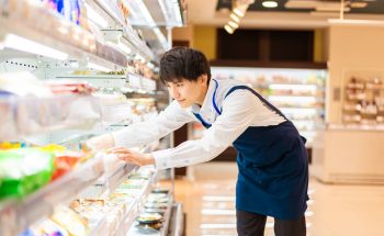 Man stocks shelves in a grocery store.