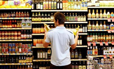 A man looks at groceries.