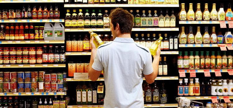 A man looks at groceries.