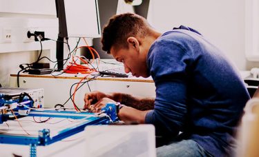 A young man is working on something.