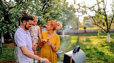 A family are grilling in their backyard
