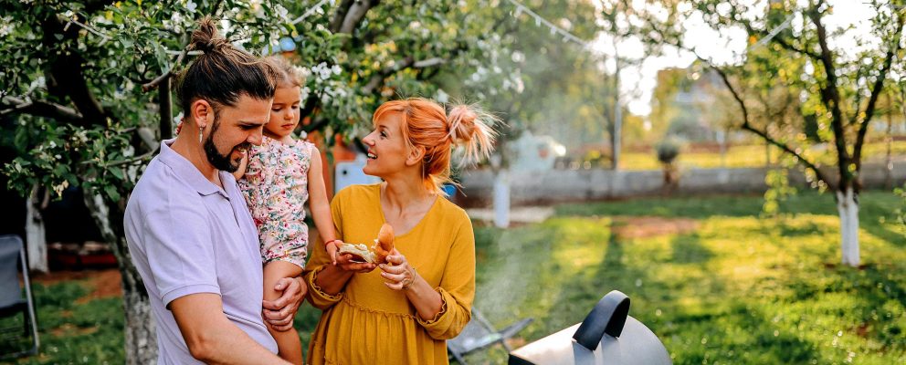 A family are grilling in their backyard
