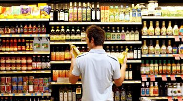A man looks at groceries.