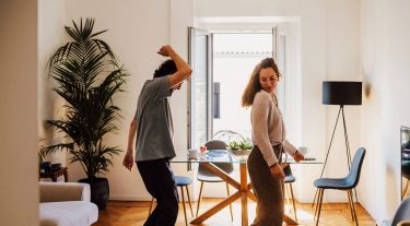 Couple dancing in their kitchen.